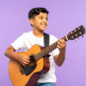Enthusiastic elementary student taking guitar lessons in music lessons at our Metro Vancouver studio, serving New West, Burnaby, and Coquitlam