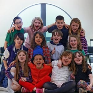 A happy group of children participating in the New West Music School summer camp, learning instruments and building confidence in Metro Vancouver.